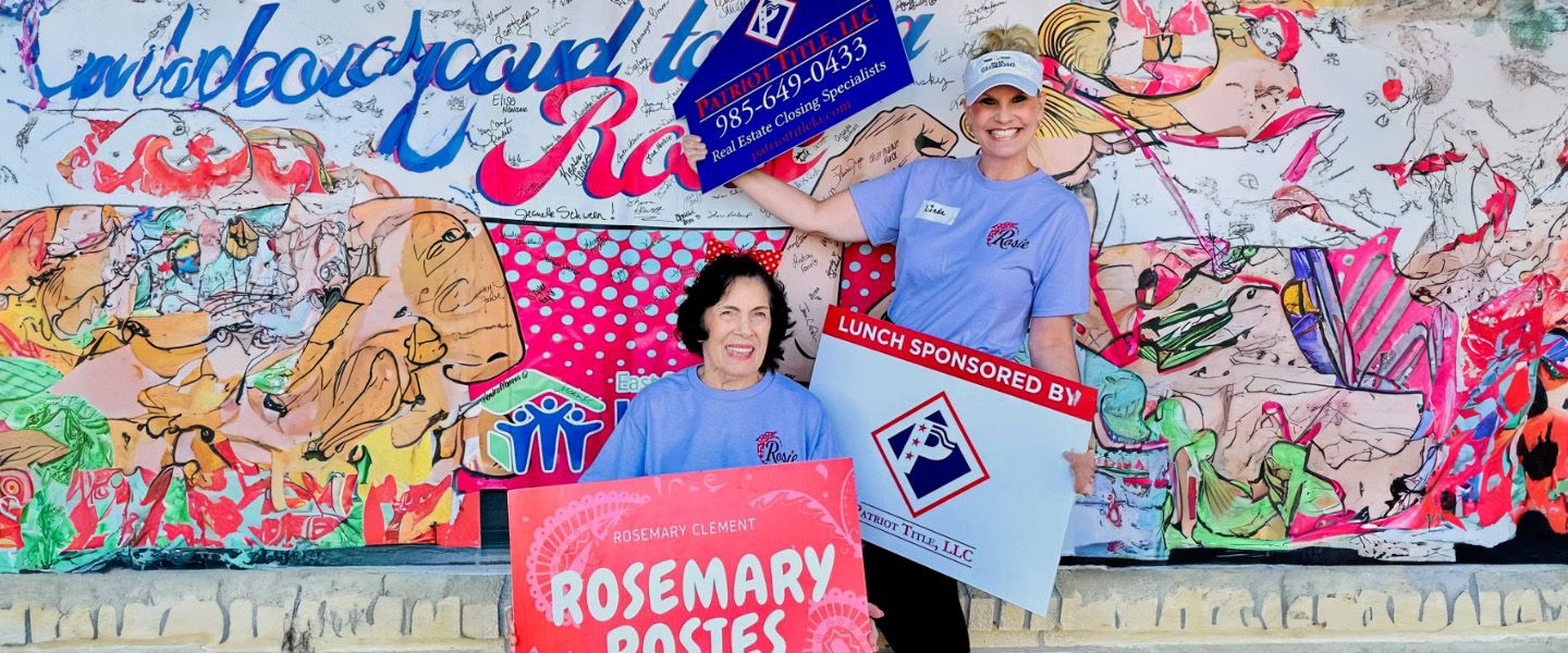 Patriot Title team members in front of a painted mural with Patriot Title and Rosemary Rosies signs